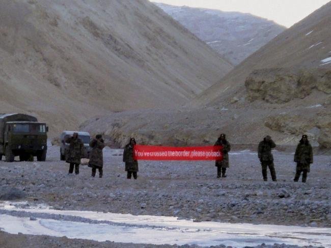 In this May 2013 photo, Chinese troops hold a banner which reads "You've crossed the border, please go back" in Ladakh, India. Picture: AP Photo, File.Source:AP