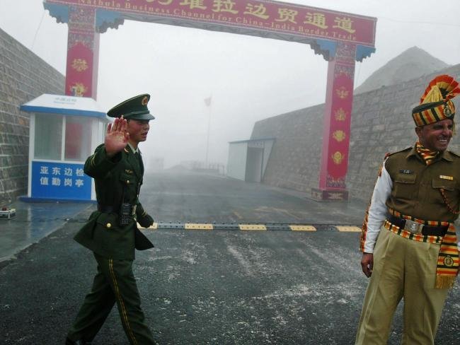 This file photo taken on July 10, 2008 shows a Chinese soldier (L) next to an Indian soldier at the Nathu La border crossing between India and China in India's northeastern Sikkim state. China's ambassador said this month that the withdrawal of Indian troops from a disputed territory is a "precondition" for peace. Picture: AFP PHOTO / DIPTENDU DUTTASource:AFP